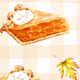 Slice of pumpkin pie with whipped cream on a checkered background