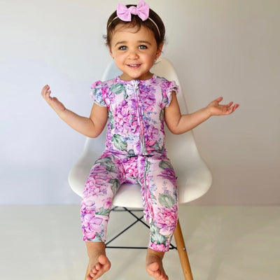 Bums & Roses - Baby & Kids Bamboo Pajamas - You Had Me At Hydrangea Ruffle Zipper Romper - Cap Sleeves - Image 1